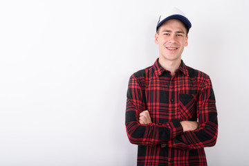 Young handsome man wearing baseball cap and red checkered shirt 