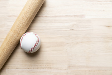 baseball and baseball bat on wooden table background, close up