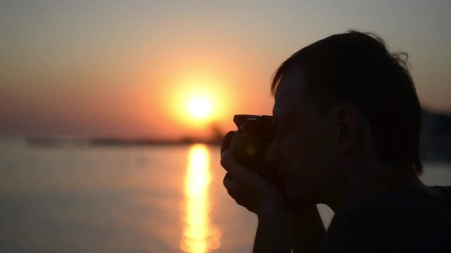 Photographer working at sunset on the beach