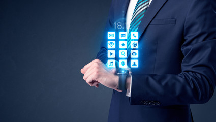Businessman wearing smartwatch with application icons.