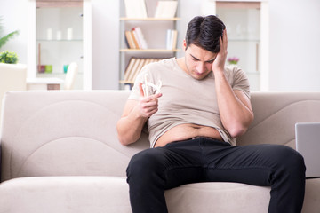 Man measuring body fat with calipers