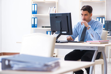 Handsome businessman employee sitting at his desk in office