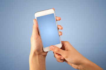 Female fingers touching blank smartphone