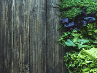 overhead close up view of five diferent herbs on wooden table with copy space