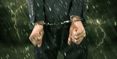 Stormy bad day concept with close handcuffed elegant man
