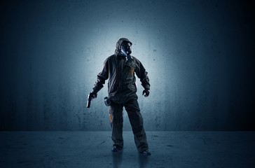 Bad agent in a dark room with arms on his hand and gas mask
