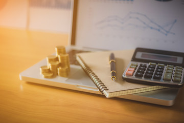 Business Real Estate Concept, House model with a key and dollar bills put on paper graph on wooden background.