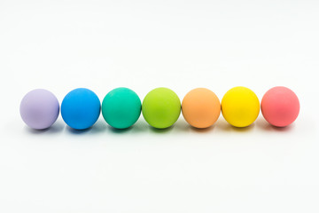 row of colourful of easter eggs on white background