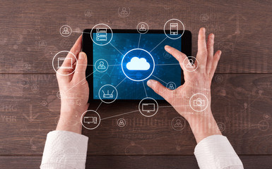 Hand touching tablet with cloud computing and online storage concept
