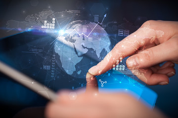 Hand using tablet with multinational worldwide estate report concept

