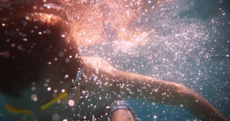 Young boy having fun swimming underwater in sea