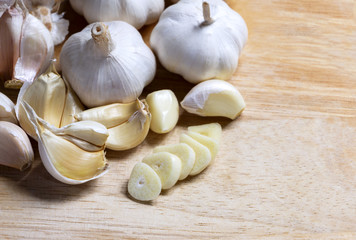 cloves garlic and whole garlic on the wooden table.