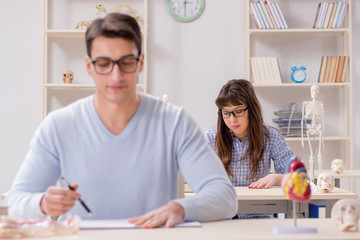 Obraz premium Two medical students studying in classroom