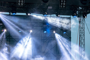 outdoor stage equipment. stage lights and searchlights during street concert 