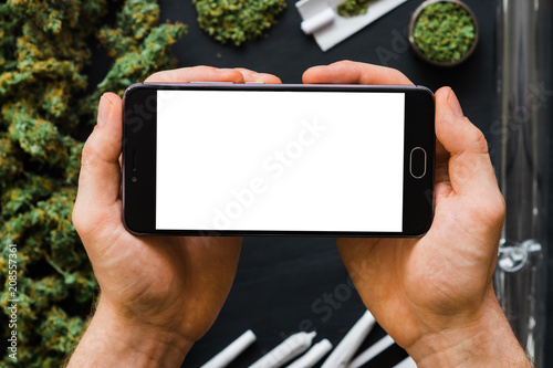Download "Black smartphone with a white screen Mock up Weed, Grinder, lighter, joint A lot of marijuana ...