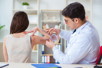 Doctor checking patients joint flexibility with gonimeter
