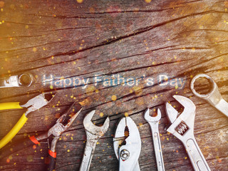 Dirty tools and equipments put on wooden background with light bokeh. Happy Father’s Day concept.