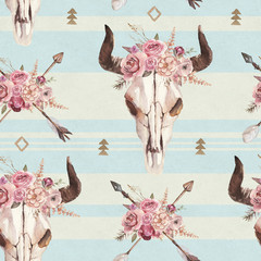 Watercolor boho seamless pattern of arrows, bull skull with horns & floral arrangement on blue background