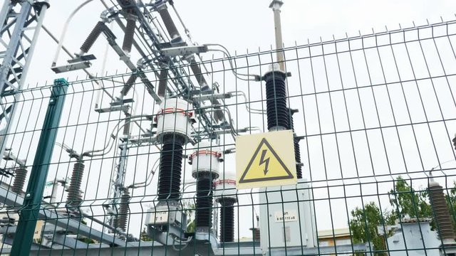 substation with danger warning sign and ceramic insulators