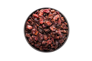 dry red barberry in clay bowl isolated on white background. Seasoning or spice top view