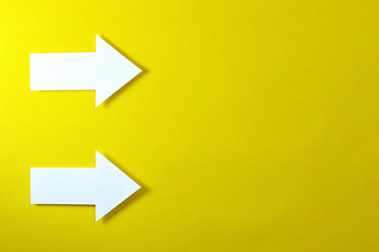 two solid arrows on yellow background