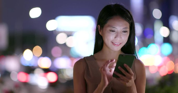 Woman use of smart phone at night
