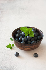 Fresh ripe blueberries in the clay plate