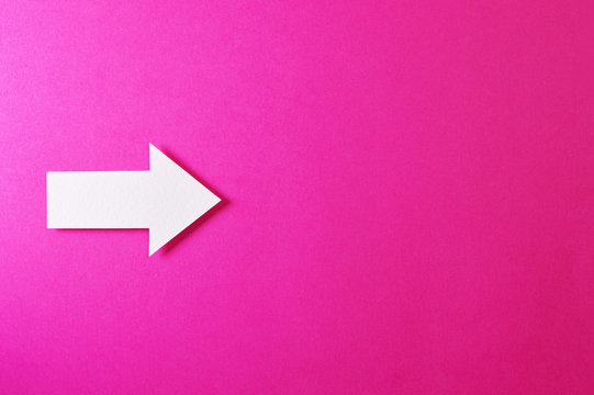 one solid arrow on pink background