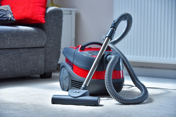 Canister vacuum cleaner for home use on the floor
