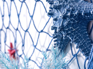 Blue net and artificial starfish made of plastic on the wall