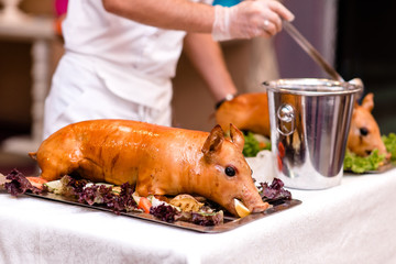 Baked piglet with vegetables and gravy. Festive show. © fotofrol