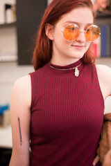 Redhead Girl in Sunglasses Showing off Pencil Tattoo