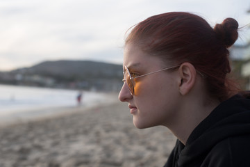 Beautiful Redhead Girl in Sunglasses Lost in Thought