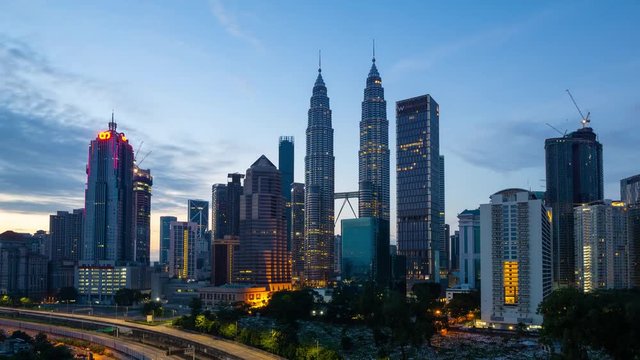 4K Time lapse of cloudy sunrise over downtown Kuala Lumpur, Malaysia. Zoom In	