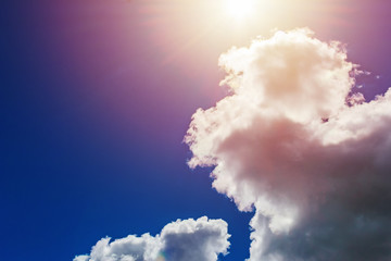 close up clouds on blue sky and rays of sun