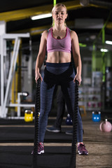 Fototapeta na wymiar athlete woman doing battle ropes cross fitness exercise