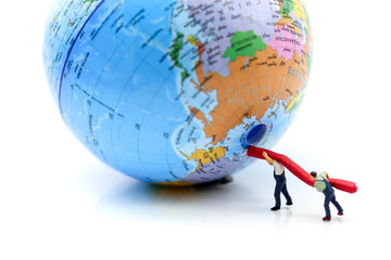Miniature people : worker team fixing a globe world map ,Earth day concept