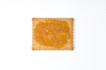 Some dry biscuits with jam on a white surface