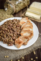 Grilled chicken with lentils on white plate. Healthy dinner