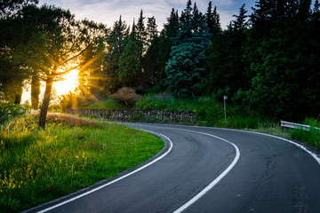 Asphalt road and curve in the italian countryside.