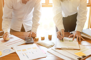 Business meeting with paper finance document on table.