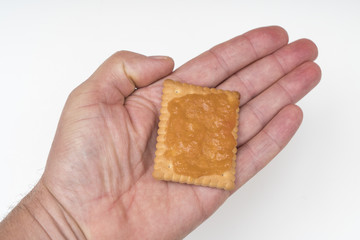 a biscuit with jam in one hand