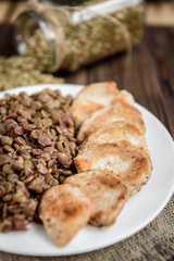 Grilled chicken with lentils on white plate. Healthy dinner