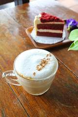 Cup of coffee and Red velvet cake on wooden table