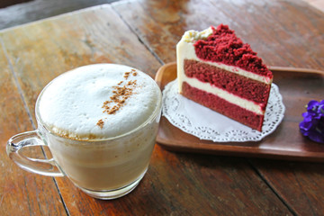 Cup of coffee and Red velvet cake on wooden table