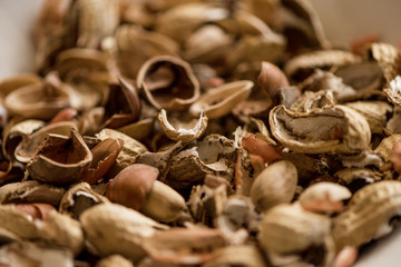 variety, mixture of different nuts on white background in white bowls 