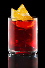 Campari and tonic in Rocks glass isolated on black