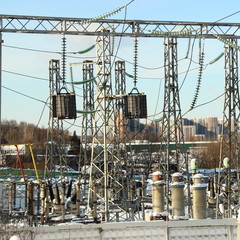 Electricity transmission - Electric substation, power supply-transformers and power line in the city against the background of multi-storey buildings