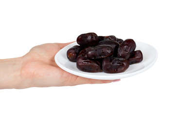 Dried dates with hand on plate isolated on white background