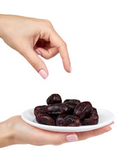 Dried dates with hand on plate isolated on white background